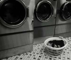 Commercial laundry machines representing essential annual maintenance tasks such as dryer vent cleaning for strata buildings in Surrey.